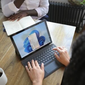 People working on a laptop with Microsoft Office